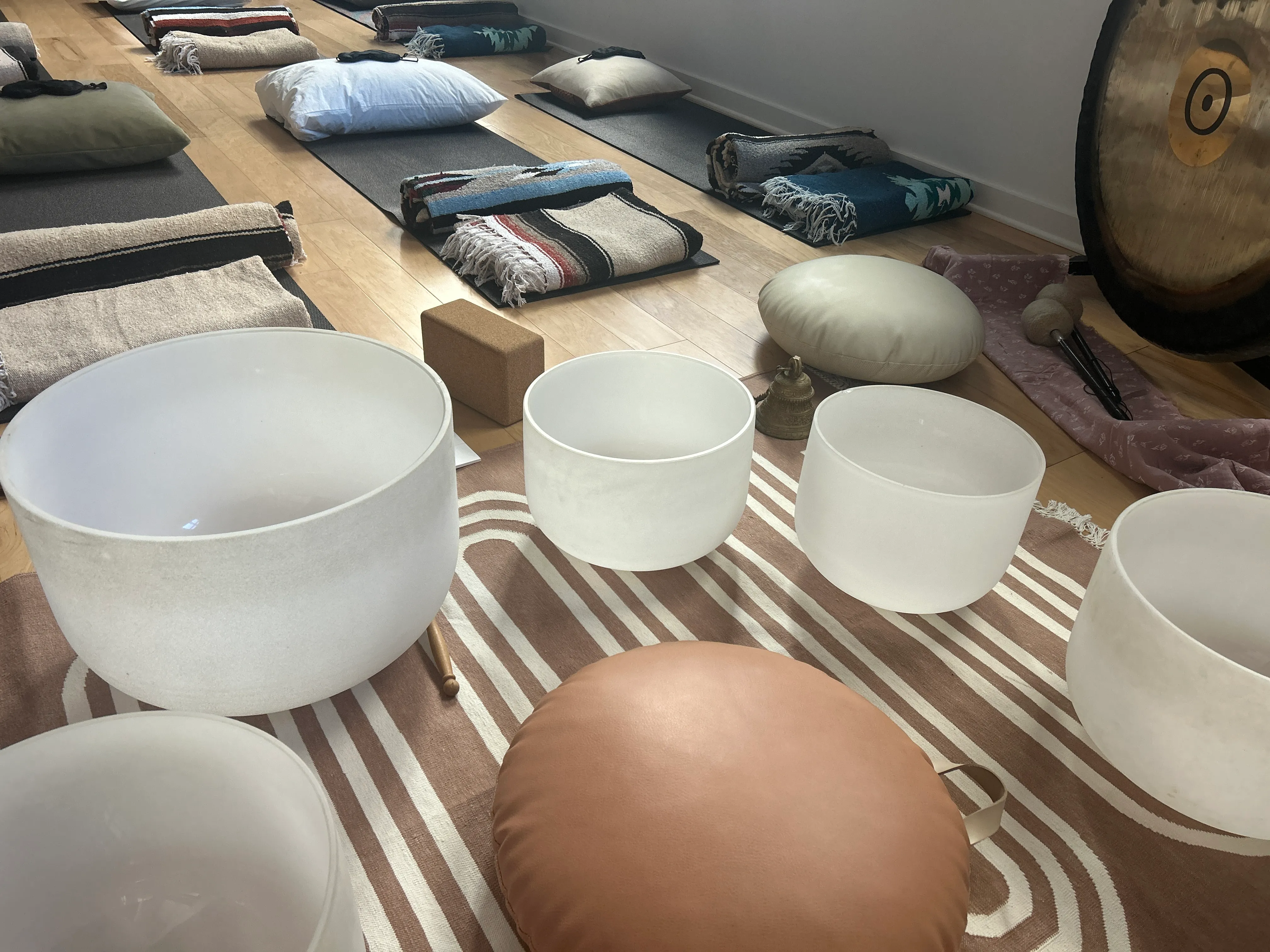 Crystal singing bowls arranged for a sound bath